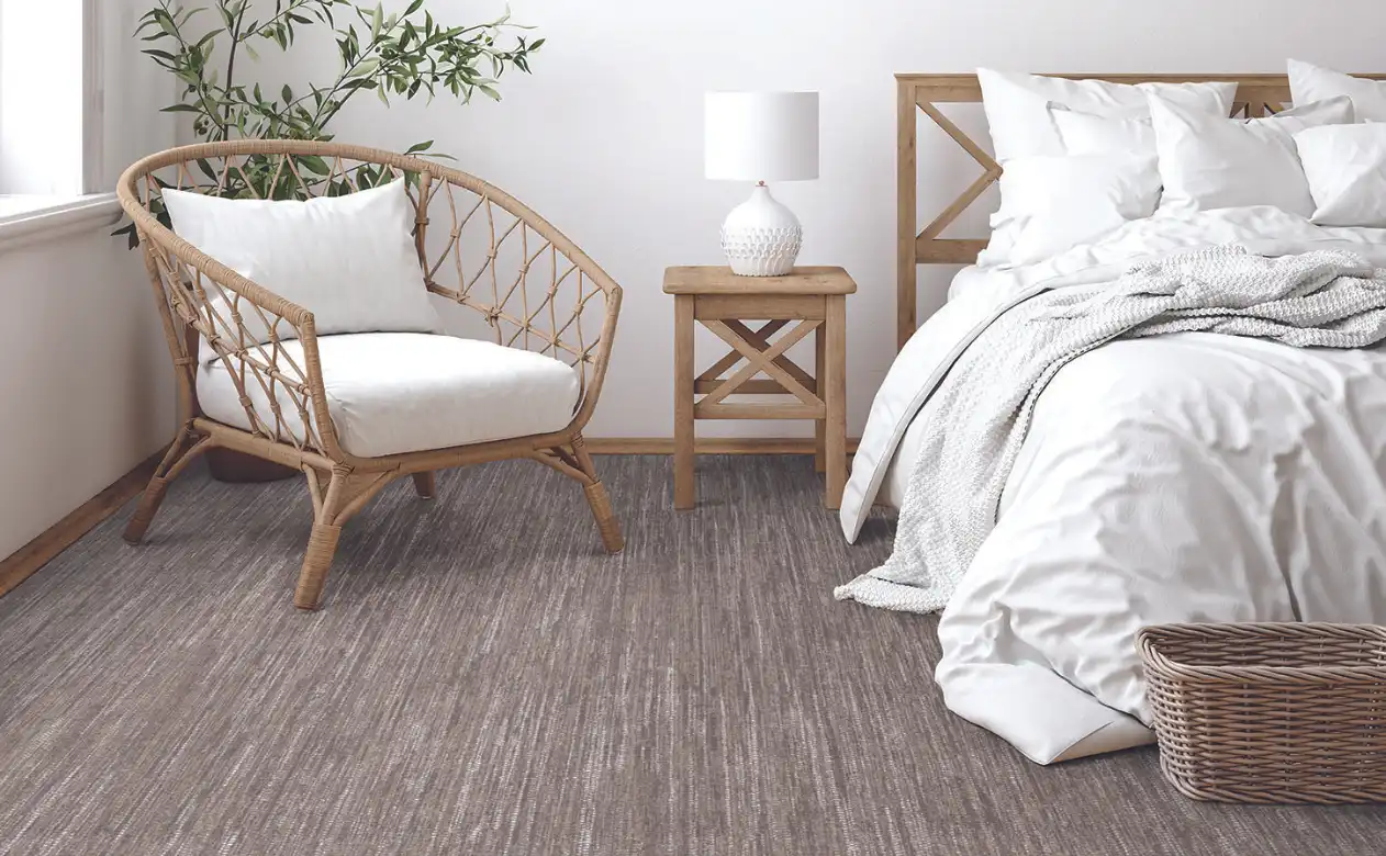 Wicker bedroom with brown Berber carpeting. 